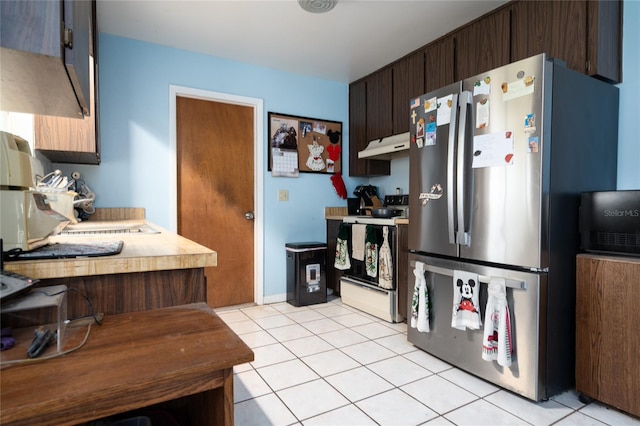 kitchen with stainless steel refrigerator, dark brown cabinetry, light tile patterned floors, and white range with electric stovetop