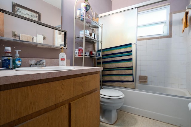 full bathroom with toilet, vanity, and shower / bath combination with glass door