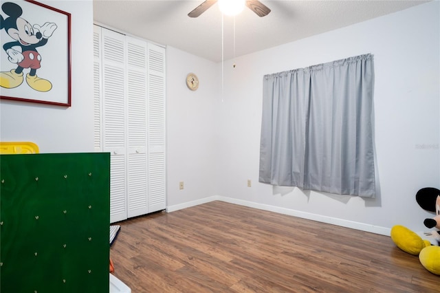 unfurnished bedroom with hardwood / wood-style floors, ceiling fan, and a closet