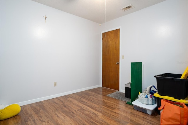 misc room featuring hardwood / wood-style flooring and a textured ceiling