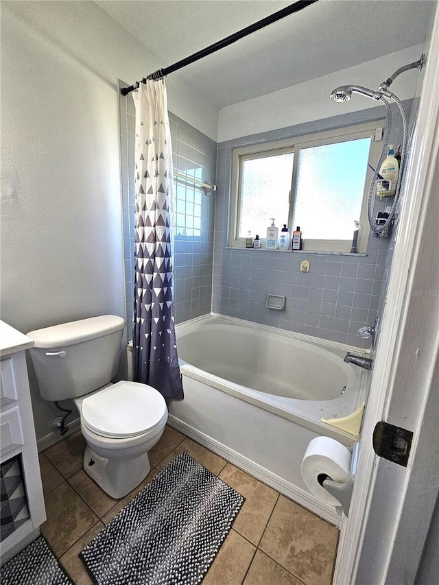 bathroom featuring tile patterned flooring, shower / bath combo, and toilet