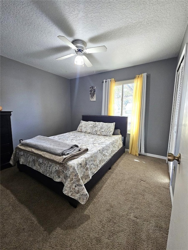 carpeted bedroom featuring a textured ceiling, a closet, and ceiling fan