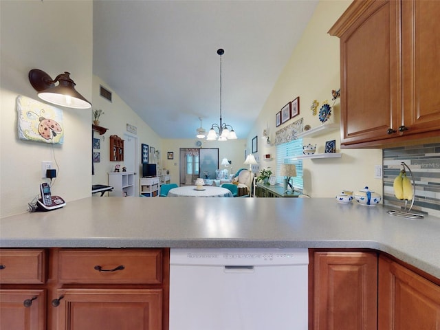 kitchen featuring dishwasher, lofted ceiling, backsplash, hanging light fixtures, and an inviting chandelier