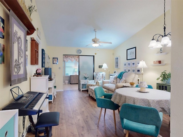 living room with ceiling fan and light hardwood / wood-style flooring