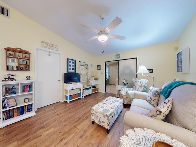 living room featuring vaulted ceiling, ceiling fan, and hardwood / wood-style floors