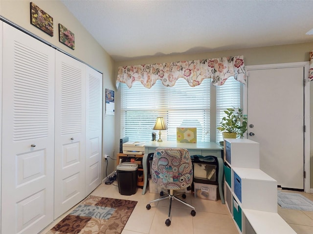 home office with light tile patterned floors and a textured ceiling