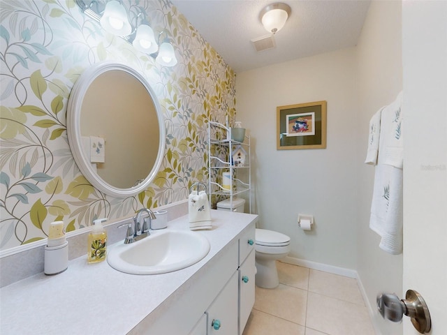 bathroom with vanity, tile patterned flooring, toilet, and a textured ceiling