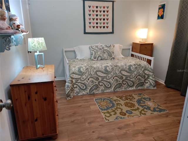 bedroom with hardwood / wood-style flooring