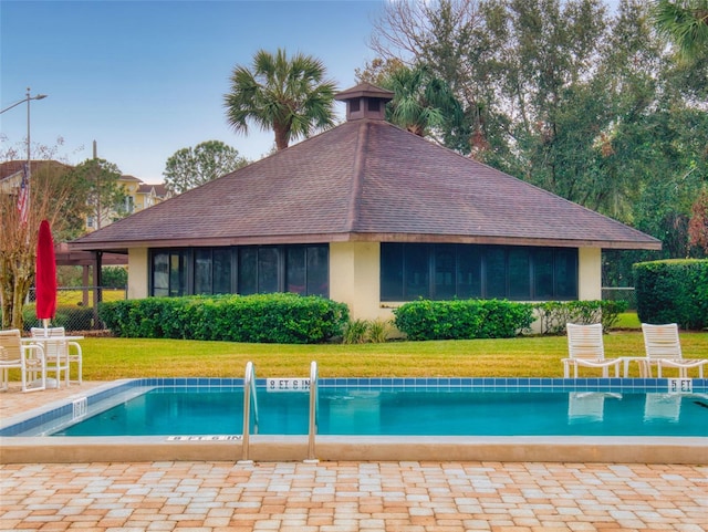 view of pool featuring a patio area and a lawn