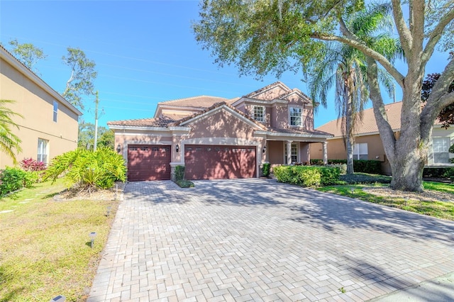 view of front of home with a garage and a front yard