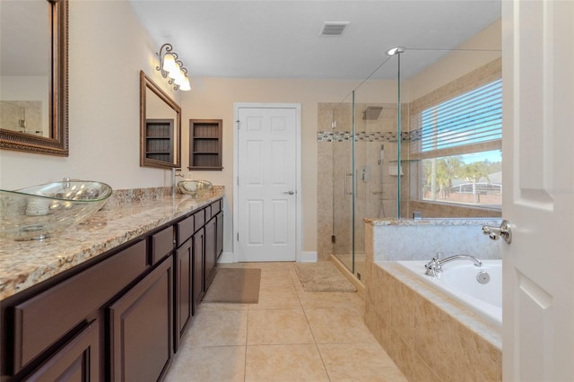 full bath with double vanity, tile patterned floors, visible vents, a shower stall, and a bath