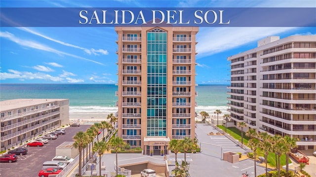 view of building exterior with a water view and a view of the beach