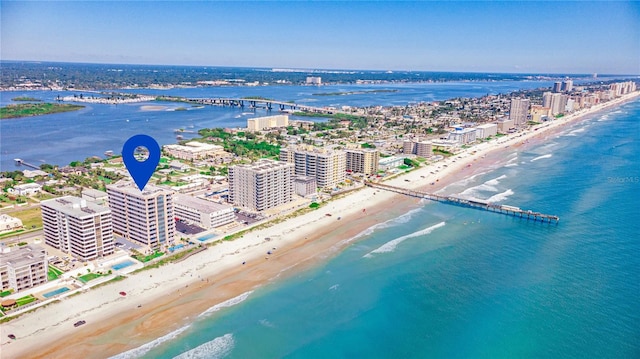 drone / aerial view with a water view and a beach view