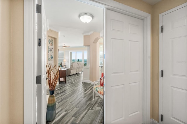 hall with light hardwood / wood-style flooring and ornamental molding