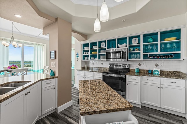 kitchen with white cabinetry, appliances with stainless steel finishes, sink, and an island with sink