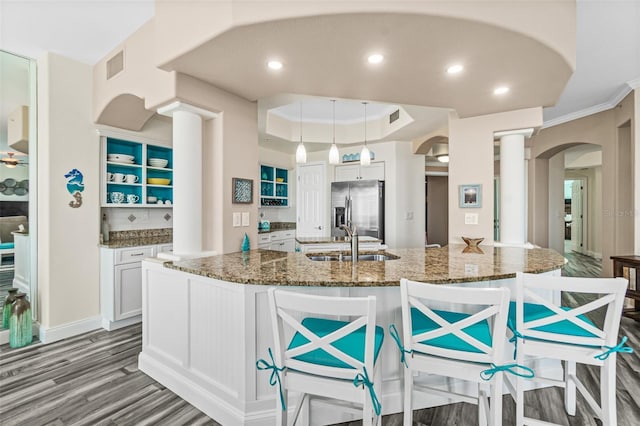 kitchen with white cabinetry, sink, pendant lighting, and stainless steel fridge with ice dispenser