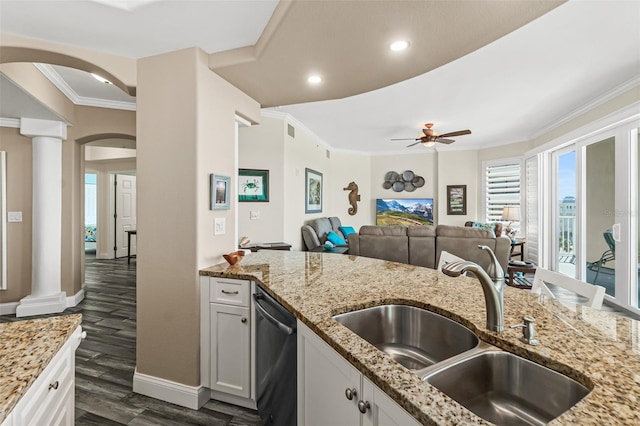 kitchen featuring dark wood-type flooring, sink, white cabinetry, dishwasher, and decorative columns