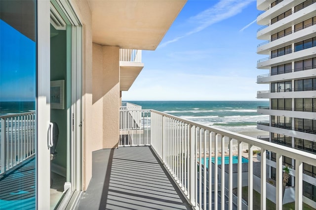 balcony with a beach view and a water view