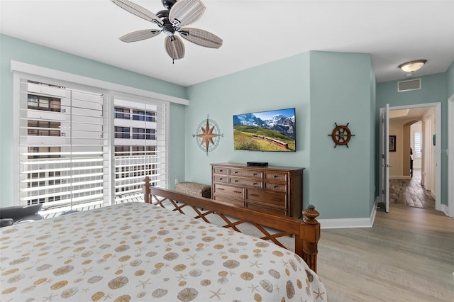 bedroom with multiple windows, light hardwood / wood-style flooring, and ceiling fan