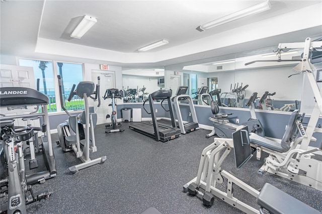 gym featuring a tray ceiling