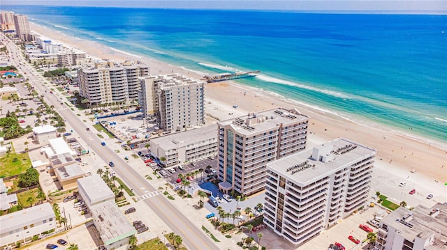 bird's eye view featuring a view of the beach and a water view