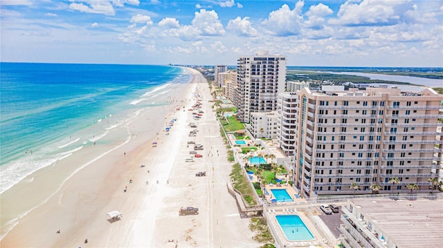 drone / aerial view with a beach view and a water view