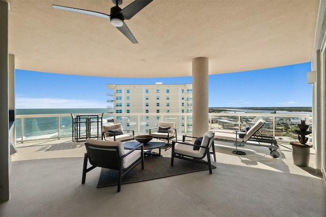 view of patio / terrace featuring a water view, ceiling fan, and a balcony