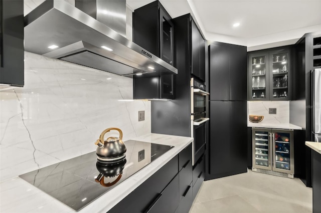 kitchen with tasteful backsplash, stainless steel double oven, black electric stovetop, beverage cooler, and range hood