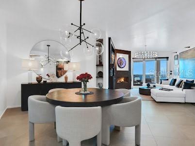 dining room with light tile patterned flooring and an inviting chandelier