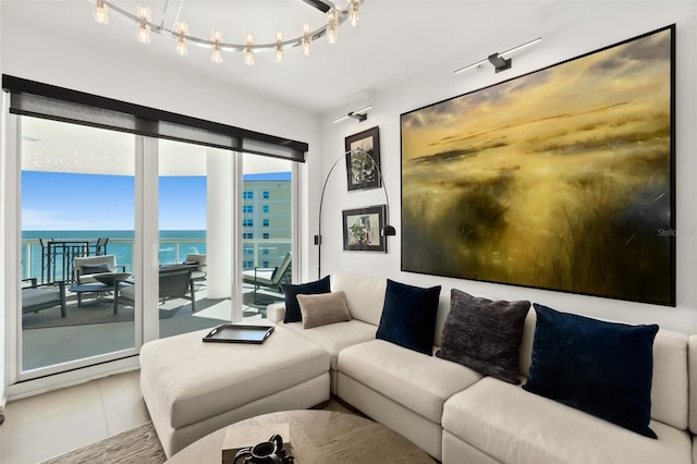 living room with a water view and tile patterned flooring