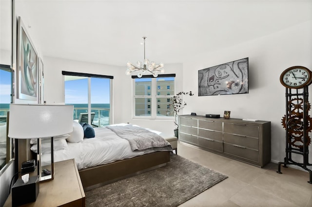 bedroom with a water view and a notable chandelier