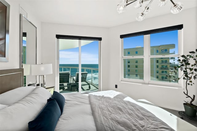 bedroom featuring access to outside and a water view