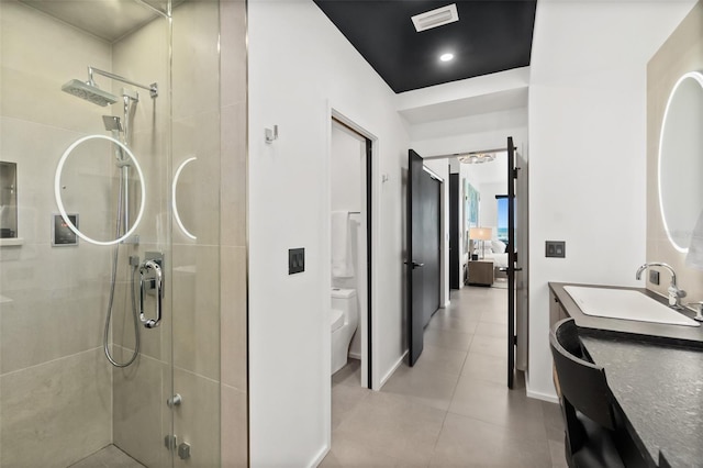 bathroom with an enclosed shower, vanity, and toilet