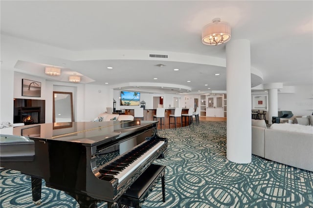 misc room featuring a fireplace and decorative columns