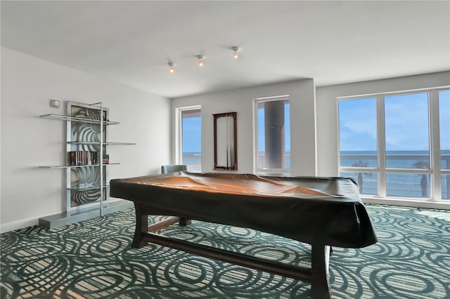 game room featuring a water view, pool table, and a wealth of natural light