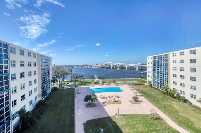 view of pool featuring a patio and a water view