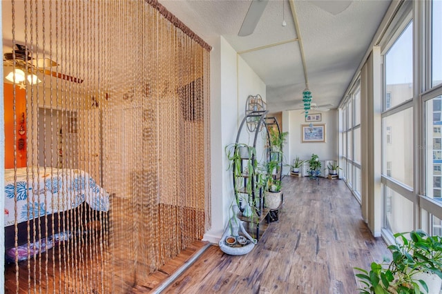 corridor featuring hardwood / wood-style flooring and a textured ceiling