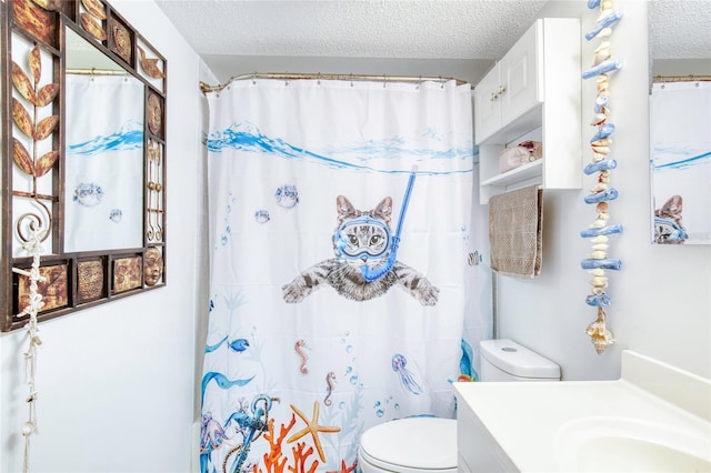 bathroom with vanity, toilet, a textured ceiling, and a shower with shower curtain