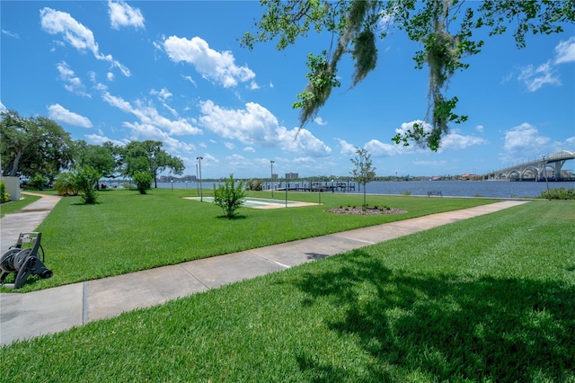 view of community with a yard and a water view