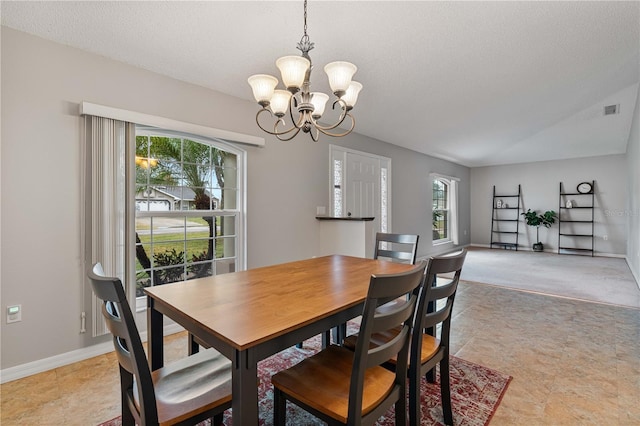 dining space with an inviting chandelier and a textured ceiling