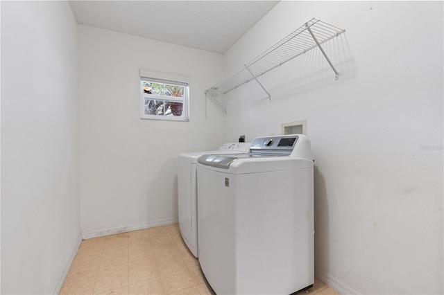 washroom with separate washer and dryer