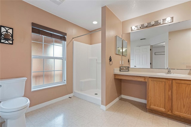 bathroom with a healthy amount of sunlight, vanity, toilet, and a shower