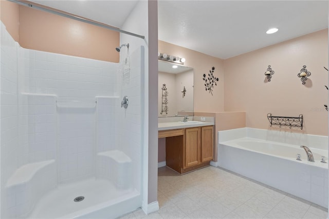 bathroom featuring vanity and shower with separate bathtub