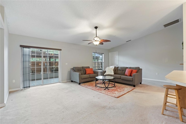 living room with vaulted ceiling, carpet flooring, and ceiling fan