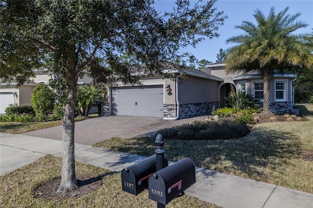 view of front of home with a garage and a front lawn