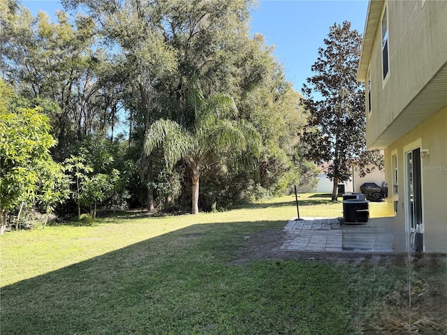 view of yard featuring central AC and a patio area