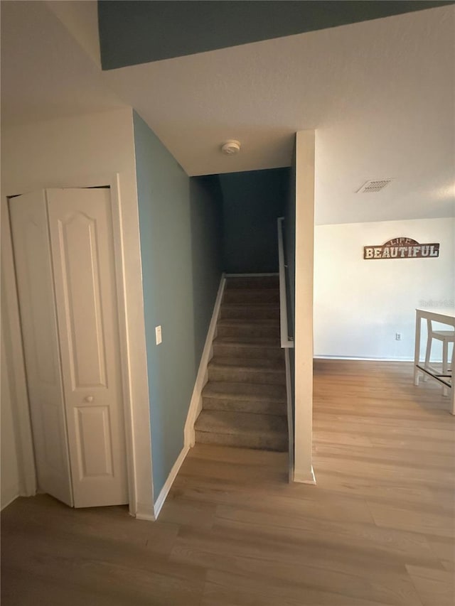 stairs with hardwood / wood-style flooring