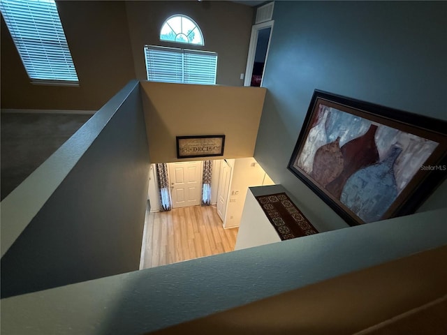 staircase with hardwood / wood-style floors