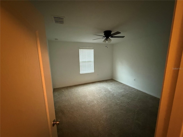 empty room featuring ceiling fan and carpet floors