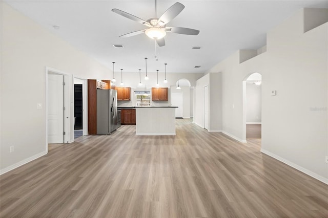 unfurnished living room with light hardwood / wood-style flooring and ceiling fan